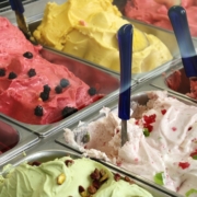 Image of a variety of ice cream flavors in a commercial freezer case.